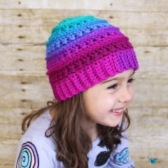 crochet textured beanie in bright colors worn by a girl