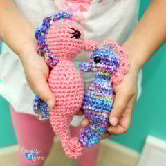 two crochet seahorses in two sizes