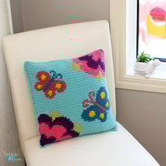 crochet pillow with butterflies and flowers