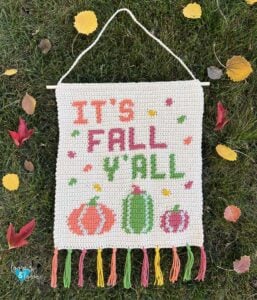 crochet wall hanging with It's Fall Y'all written on it