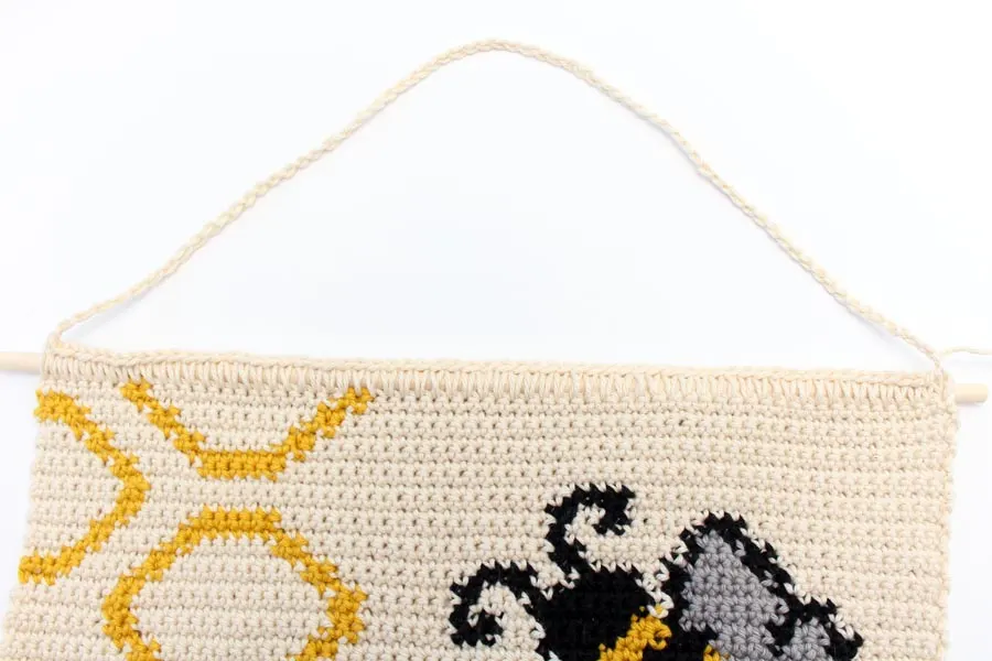 crochet panel featuring honeycomb, a bee, and the bee happy title