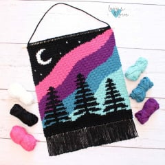 crochet wall hanging with northern lights pictured