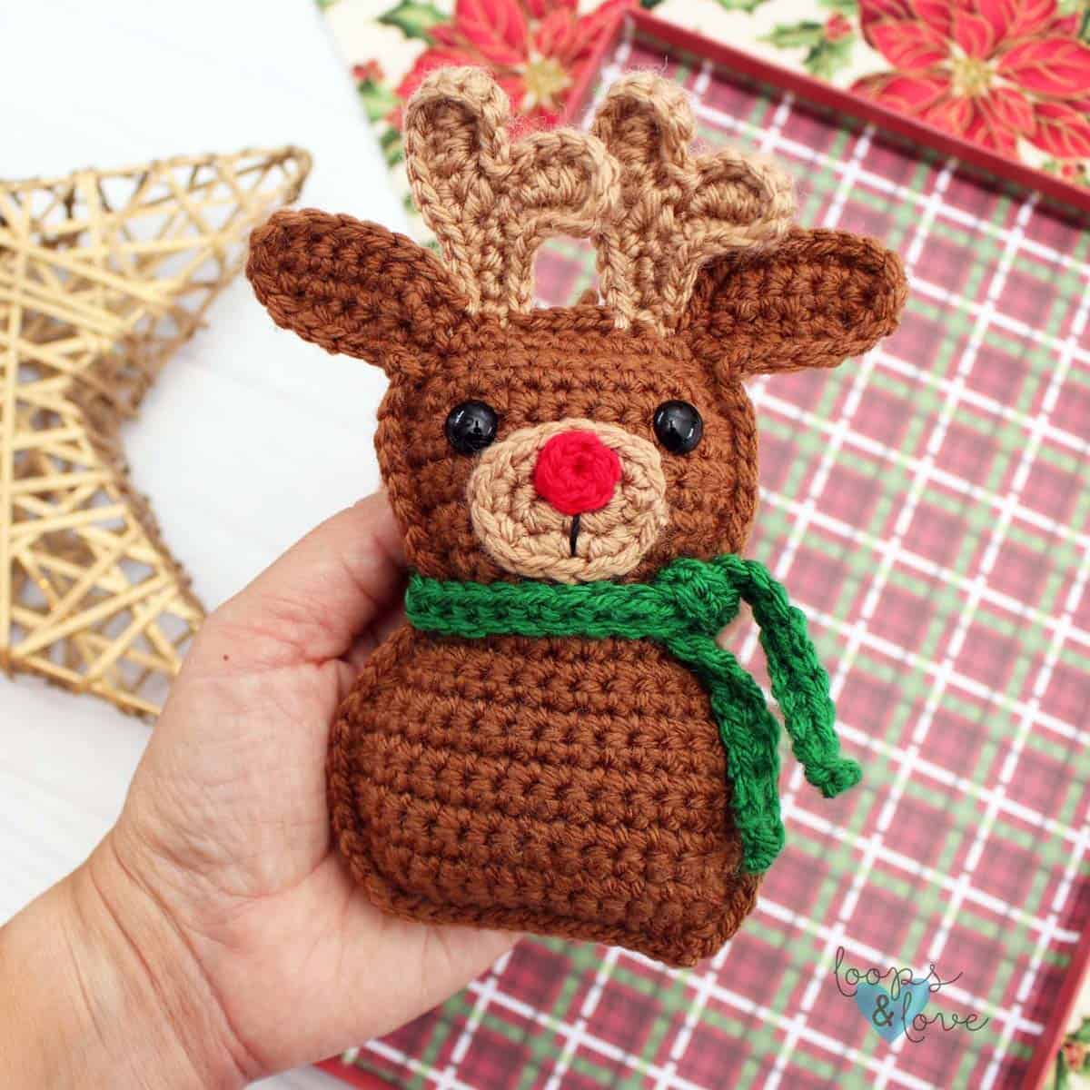 Crochet ragdoll reindeer Christmas ornament with red nose and green scarf