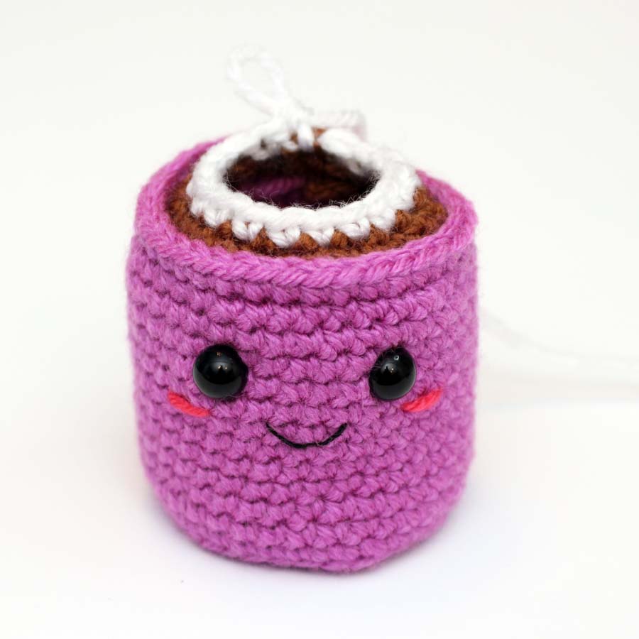 adding the whipped cream to the hot chocolate cup crochet