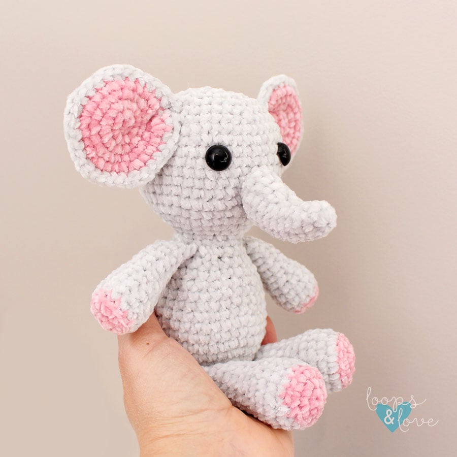 crochet mini elephant amigurumi in sitting in a hand