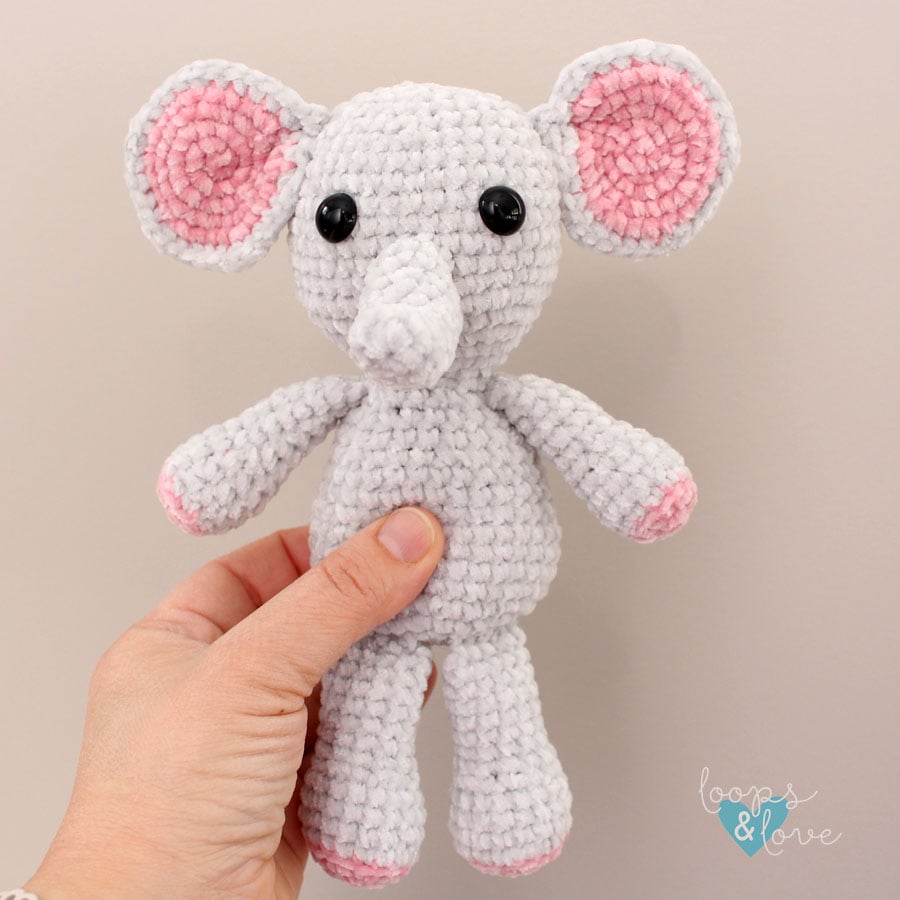 crochet mini elephant amigurumi being held in a hand