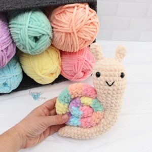 crochet rainbow snail in soft plush yarn